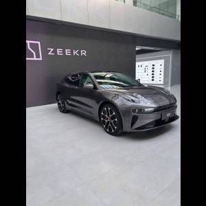 A sleek grey car displayed under the "ZEEKR" logo in a modern indoor space.