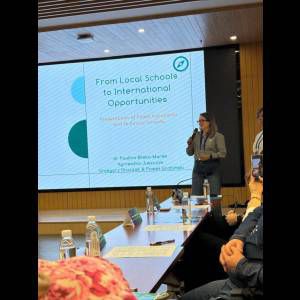 A presentation titled "From Local Schools to International Opportunities" is being held, featuring four speakers.