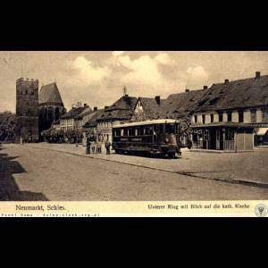 A historic street scene in Neumarkt, featuring a tram, people, and a church in the background.
