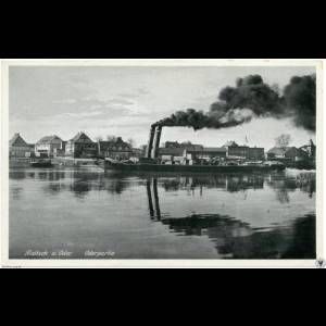 A historic black-and-white image shows a smoke-belching steamer on a river beside quaint houses.